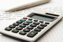 A calculator and pen indicate use by a professional for business purposes.